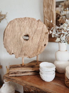 Vintage reclaimed wooden wheel on stand